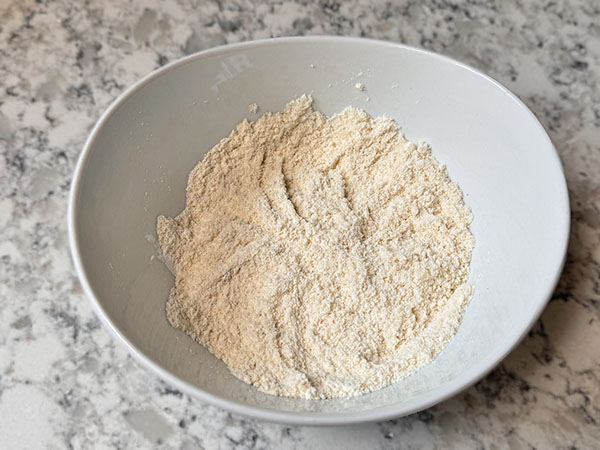 Dry ingredients for apple donut pancakes in a bowl.