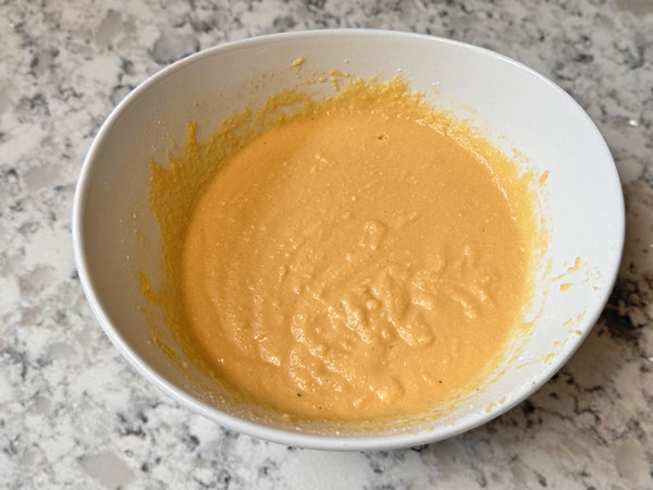 Cinnamon-sugar apple pancakes batter in a bowl.
