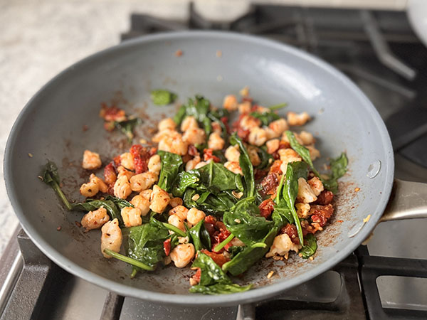 Cooked salmon stuffing in a skillet on stove top.