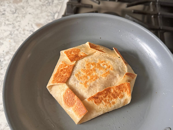 Tortilla wrap quickly toasted in a skillet for a beautiful golden brown look.