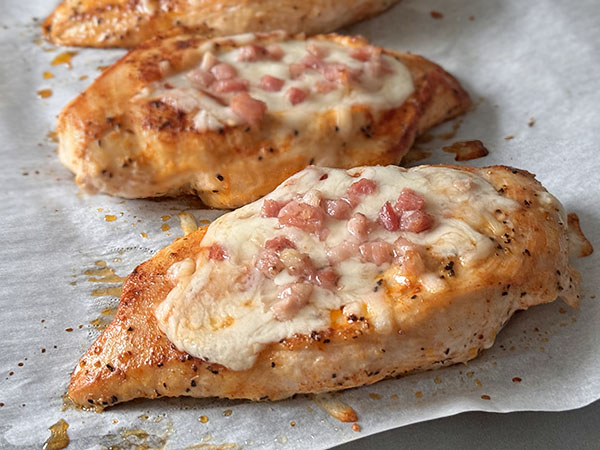 Oven finished chicken breasts stuffed with marinara, mozzarella and pancetta.