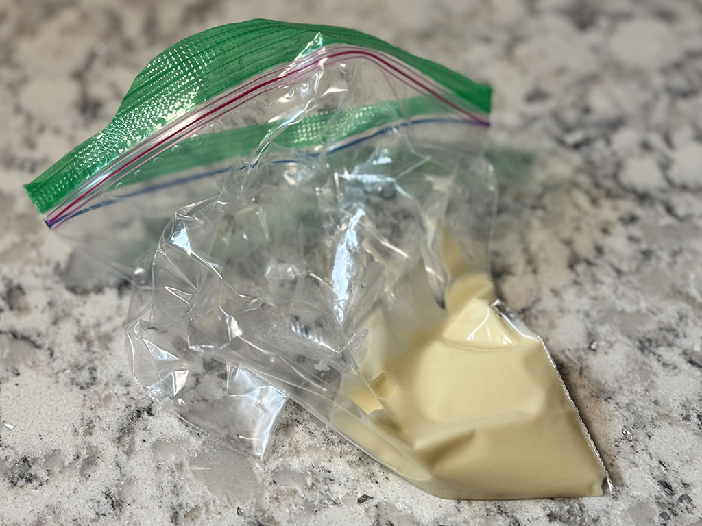 Melted white chocolate transferred to a ziplock bag.