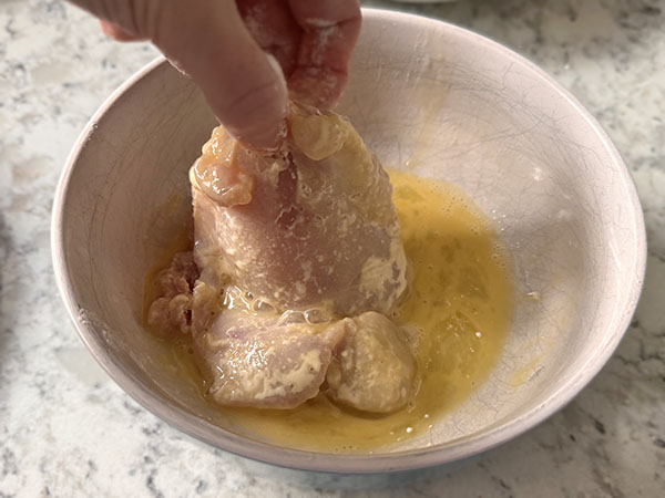Boneless skinless chicken thigh dipped in egg mixture.