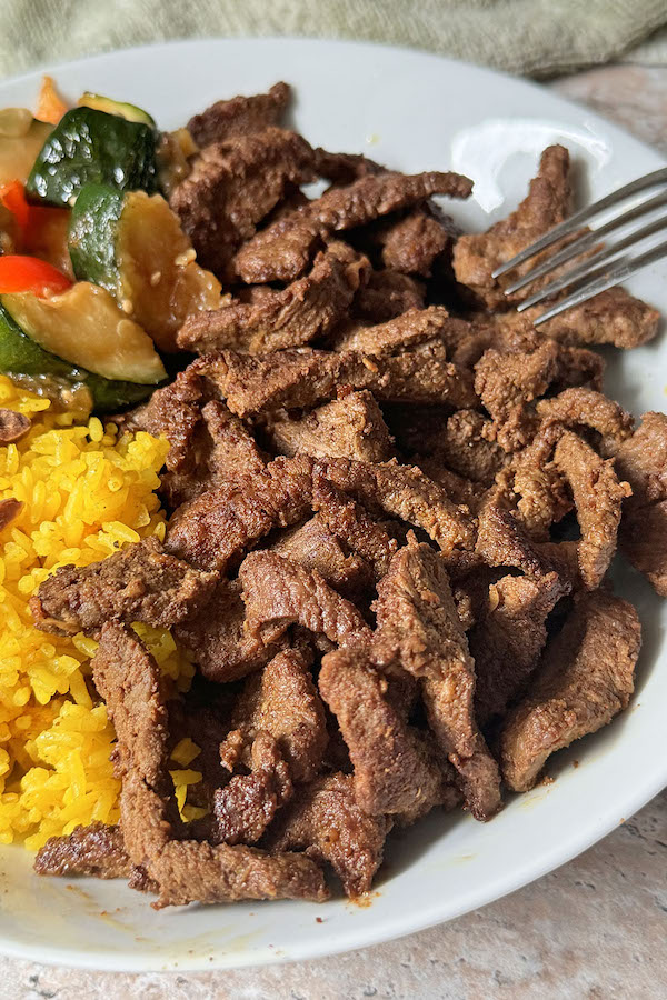 Homemade beef shawarma served with turmeric rice and veggies.