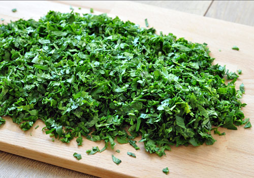 Chopped fresh parsley on a cutting board.