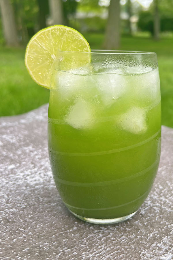 Ice cold Margarita with limeade garnished with a slice of lime served on Halloween