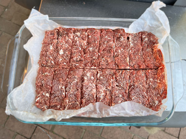 Meat mixture cut into finger length sausages.