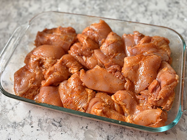 Chicken thighs covered in a simple marinade of lemon juice, avocado oil, paprika, salt and black pepper.