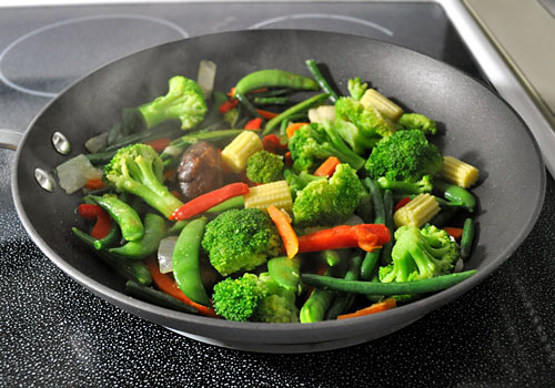 Easy Stir-Fry Vegetables photo instruction 1 Coscto Kirkland Stir Fry vegetables mix cooking on stove top in a large pan.