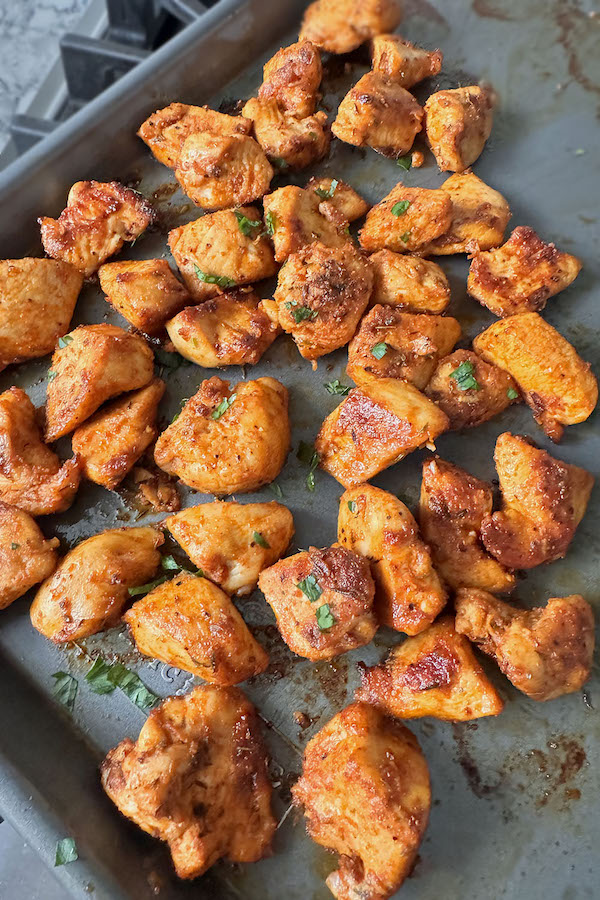 Beautiful golden brown chicken bites garnished with fresh parsley.