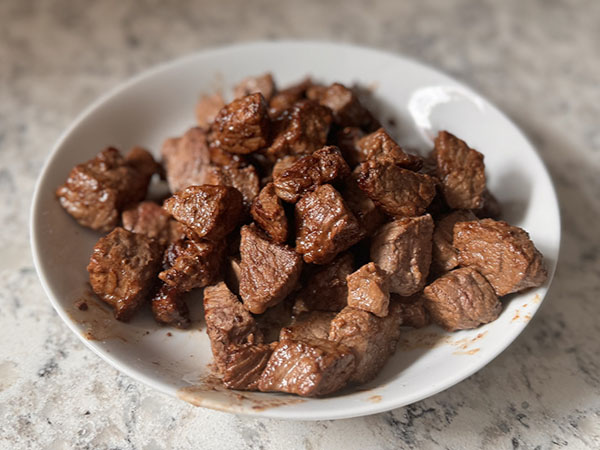 Browned beef in a shallow bowl.